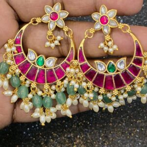 Jadau Kundan earrings with ruby-pink, emerald-green and white stones, gold-tone detailing, and pearl and green bead danglers.