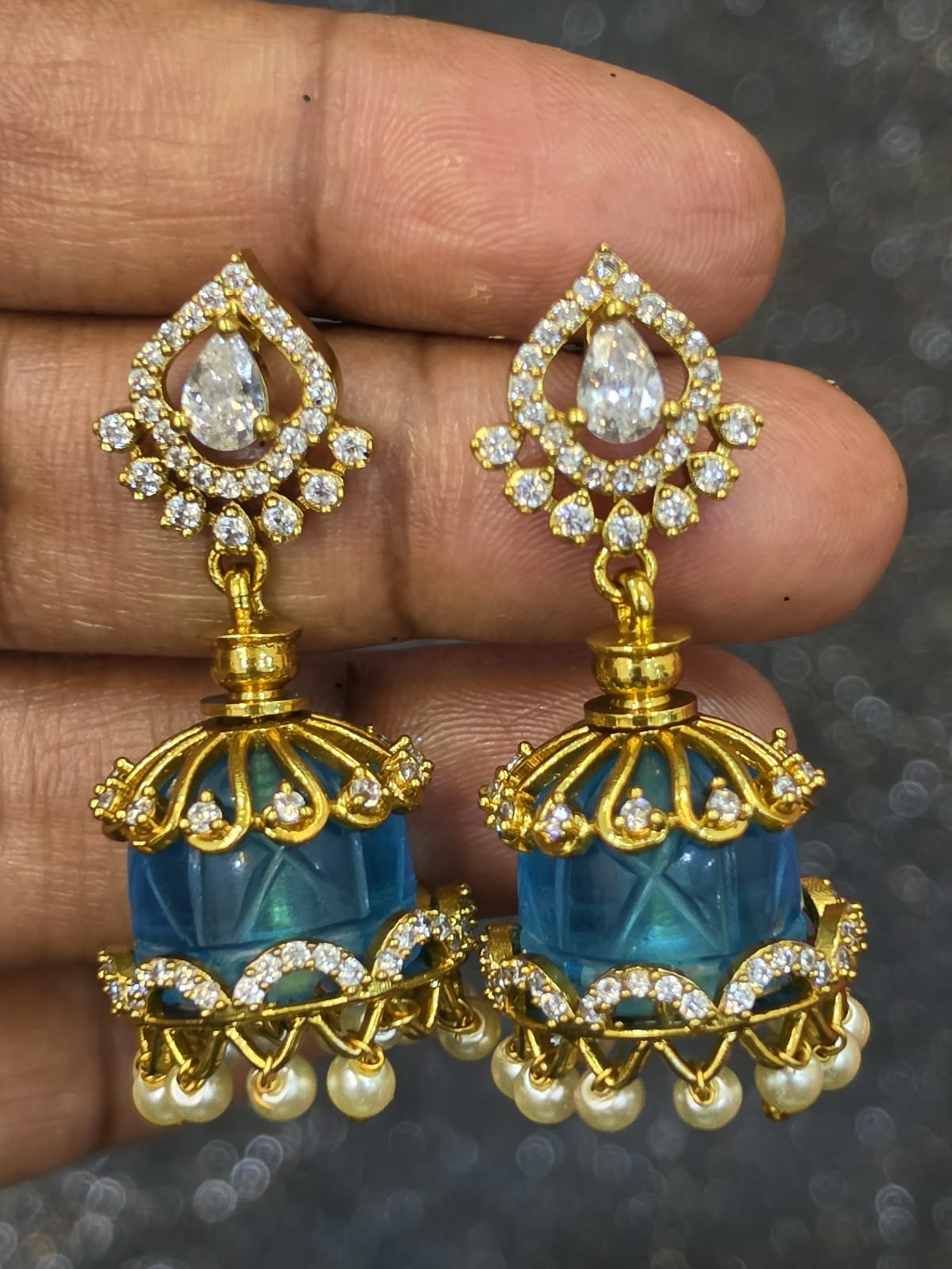 "Micro-gold plated Jadau Kundan multi-colour jhumka earrings with sparkling teardrop Kundan stones, colourful dome-shaped beads and pearl drops, available in pink, yellow, black, blue and red."