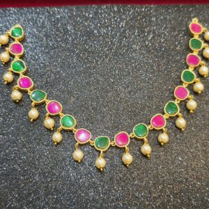 Microgold plated Jadau Kundan necklace with earrings with alternating pink and green stones, gold-tone detailing, and cream pearl drop accents.