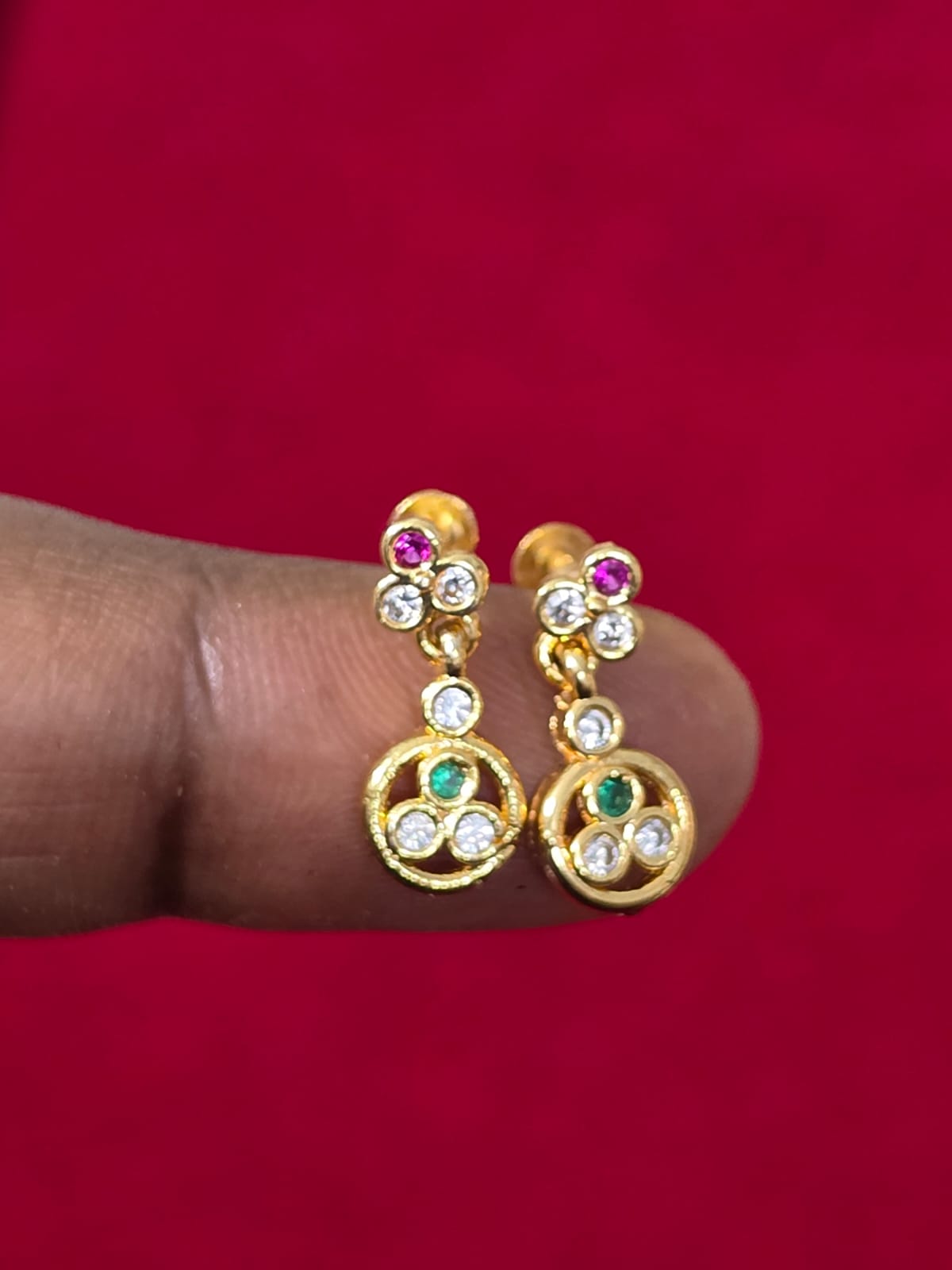 Pair of Pure Panchaloham gold-toned earrings featuring floral detailing, sparkling white stones, pink and green gemstone accents, and circular drop pendants