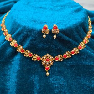 Pure Panchaloham coral and pearl jewellery set featuring a gold-toned necklace with red coral stones, pearl accents, floral detailing, and matching drop earrings